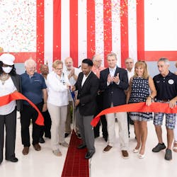 Inga Carus, co-founder of CL Enterprises, and Aurora Mayor Richard C. Irvin, cut a ribbon to celebrate the transition of LumanAir Aviation Services to Carver Aero at the Aurora, Illinois, Municipal Airport on National Aviation Day, Aug. 19.