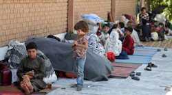 Internally displaced Afghan families, who fled from the northern province due to battle between Taliban and Afghan security forces, sit in the courtyard of the Wazir Akbar Khan mosque in Kabul on Aug. 13, 2021.