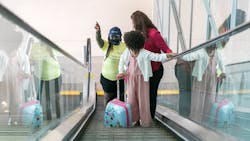 A SkySquad Team member offers assistance to travelers. A SkySquad Team member offers assistance to travelers.