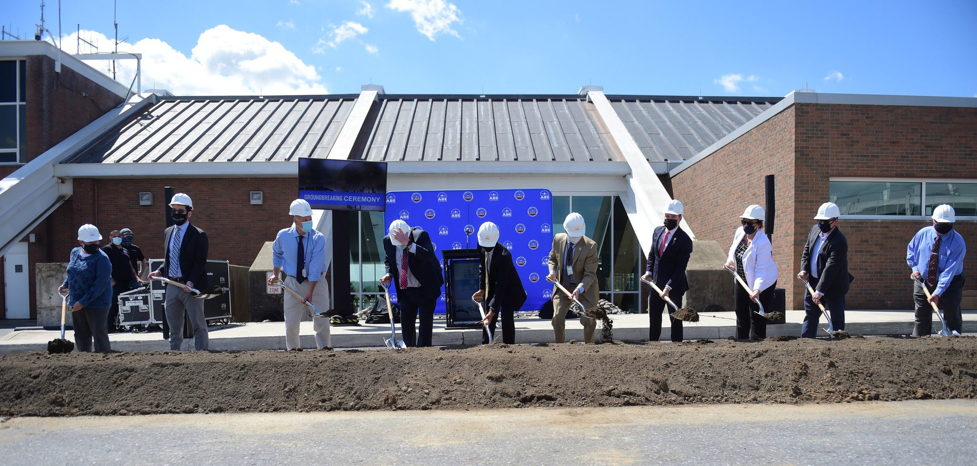 Local elected officials and staff at the Lehigh Valley International Airport held a groundbreaking in May for a 9 million connector bridge project at the airport. However, the work is now on hold due to a lawsuit contesting the bidding process.
