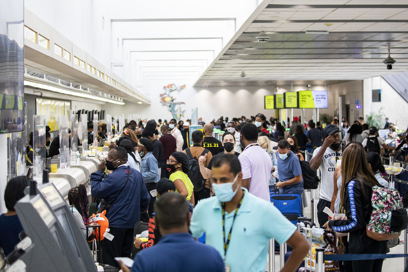 Passengers check in and wait by the Spirit Airlines ticket counter in Terminal 4 at Fort Lauderdale-Hollywood International Airport.
