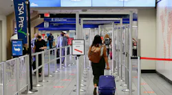 Travelers make their way to a security checkpoint at DFW International Airport.