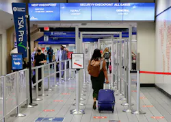 Travelers make their way to a security checkpoint at DFW International Airport. Travelers make their way to a security checkpoint at DFW International Airport.