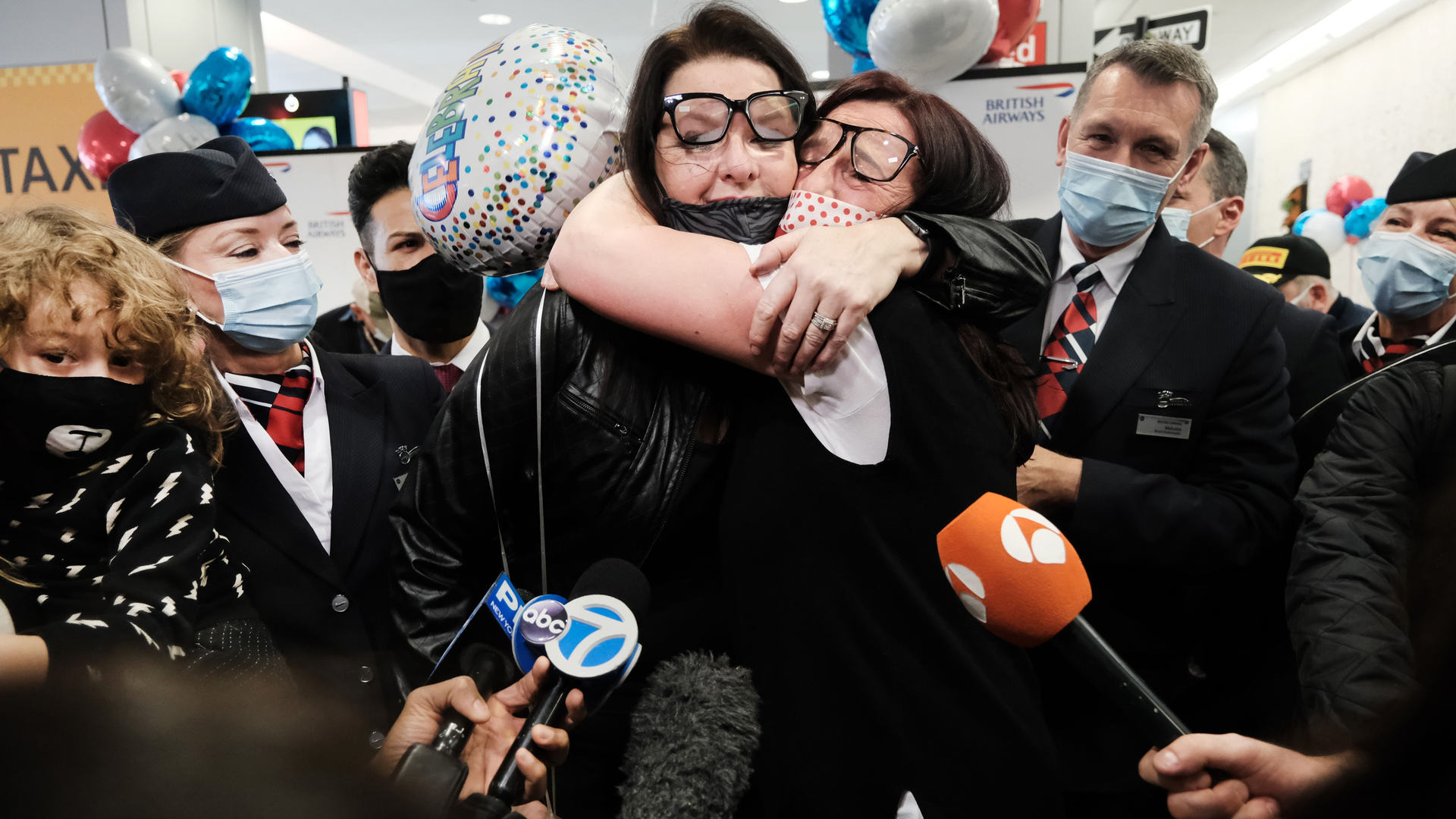 Jill Chambers (R) of Manchester, England is reunited with her sister Louise as passengers arrive from the first British Airways flight to arrive since the U.S. lifted pandemic travel restrictions on Nov. 8, in New York City.