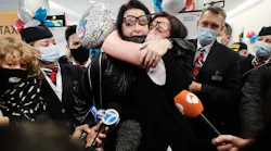 Jill Chambers (R) of Manchester, England is reunited with her sister Louise as passengers arrive from the first British Airways flight to arrive since the U.S. lifted pandemic travel restrictions on Nov. 8, in New York City.