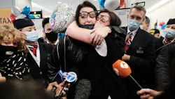 Jill Chambers (R) of Manchester, England is reunited with her sister Louise as passengers arrive from the first British Airways flight to arrive since the U.S. lifted pandemic travel restrictions on Nov. 8, in New York City. Jill Chambers (R) of Manchester, England is reunited with her sister Louise as passengers arrive from the first British Airways flight to arrive since the U.S. lifted pandemic travel restrictions on Nov. 8, in New York City.