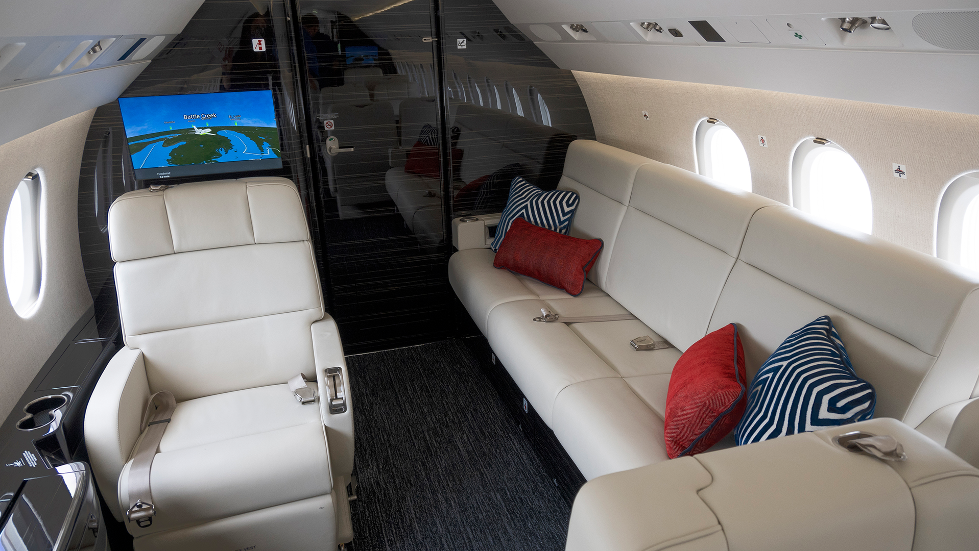 The overall design of this recently refurbished Falcon 900EX EASy is clean and masculine with a lot of leather and dark, heavily grained veneer, mixed with textures to help soften the overall space. It was completed by Duncan Aviation.