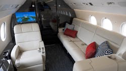 The overall design of this recently refurbished Falcon 900EX EASy is clean and masculine with a lot of leather and dark, heavily grained veneer, mixed with textures to help soften the overall space. It was completed by Duncan Aviation.