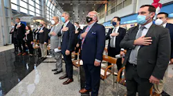 State and local officials salute the flag during a Massport ceremony at Worcester Airport.