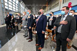 State and local officials salute the flag during a Massport ceremony at Worcester Airport.