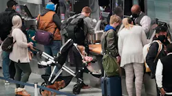 Holiday travelers — human and one canine —waited in line at the Delta ticketing counter of Terminal 1 at the Minneapolis-St. Paul International Airport on Monday.