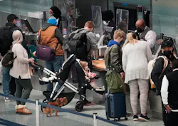 Holiday travelers — human and one canine —waited in line at the Delta ticketing counter of Terminal 1 at the Minneapolis-St. Paul International Airport on Monday.