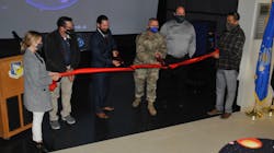 Col. Eric Felt, director of the Air Force Research Laboratory Space Vehicles Directorate and Dr. Darren Raspa, AFRL Phillips Research Site historian, cut the ribbon to open the directorate’s Legacy Portal Mission Control exhibit, at a ceremony held Nov. 15 at Kirtland AFB, N.M. Supporting them left to right: Gina Gutierrez, project manager; Bradley Rieck, senior facility engineer; Dan Von Tom, chief of the Corporate Information Office; and Victor Mace, project coordinator. Col. Eric Felt, director of the Air Force Research Laboratory Space Vehicles Directorate and Dr. Darren Raspa, AFRL Phillips Research Site historian, cut the ribbon to open the directorate’s Legacy Portal Mission Control exhibit, at a ceremony held Nov. 15 at Kirtland AFB, N.M. Supporting them left to right: Gina Gutierrez, project manager; Bradley Rieck, senior facility engineer; Dan Von Tom, chief of the Corporate Information Office; and Victor Mace, project coordinator.