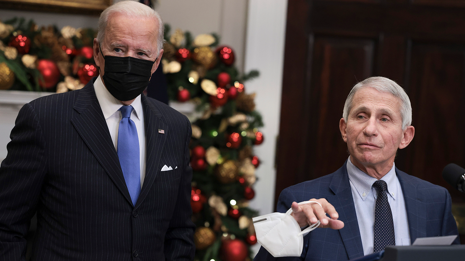 Anthony Fauci, right, Director of the National Institute of Allergy and Infectious Diseases and Chief Medical Advisor to the President, speaks alongside U.S. President Joe Biden as he delivers remarks on the omicron COVID-19 variant following a meeting of the COVID-19 response team at the White House on Nov. 29, 2021, in Washington, D.C. Fauci said Monday that vaccine rules for air travel should be considered.