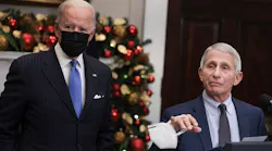 Anthony Fauci, right, Director of the National Institute of Allergy and Infectious Diseases and Chief Medical Advisor to the President, speaks alongside U.S. President Joe Biden as he delivers remarks on the omicron COVID-19 variant following a meeting of the COVID-19 response team at the White House on Nov. 29, 2021, in Washington, D.C. Fauci said Monday that vaccine rules for air travel should be considered.