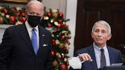 Anthony Fauci, right, Director of the National Institute of Allergy and Infectious Diseases and Chief Medical Advisor to the President, speaks alongside U.S. President Joe Biden as he delivers remarks on the omicron COVID-19 variant following a meeting of the COVID-19 response team at the White House on Nov. 29, 2021, in Washington, D.C. Fauci said Monday that vaccine rules for air travel should be considered. Anthony Fauci, right, Director of the National Institute of Allergy and Infectious Diseases and Chief Medical Advisor to the President, speaks alongside U.S. President Joe Biden as he delivers remarks on the omicron COVID-19 variant following a meeting of the COVID-19 response team at the White House on Nov. 29, 2021, in Washington, D.C. Fauci said Monday that vaccine rules for air travel should be considered.
