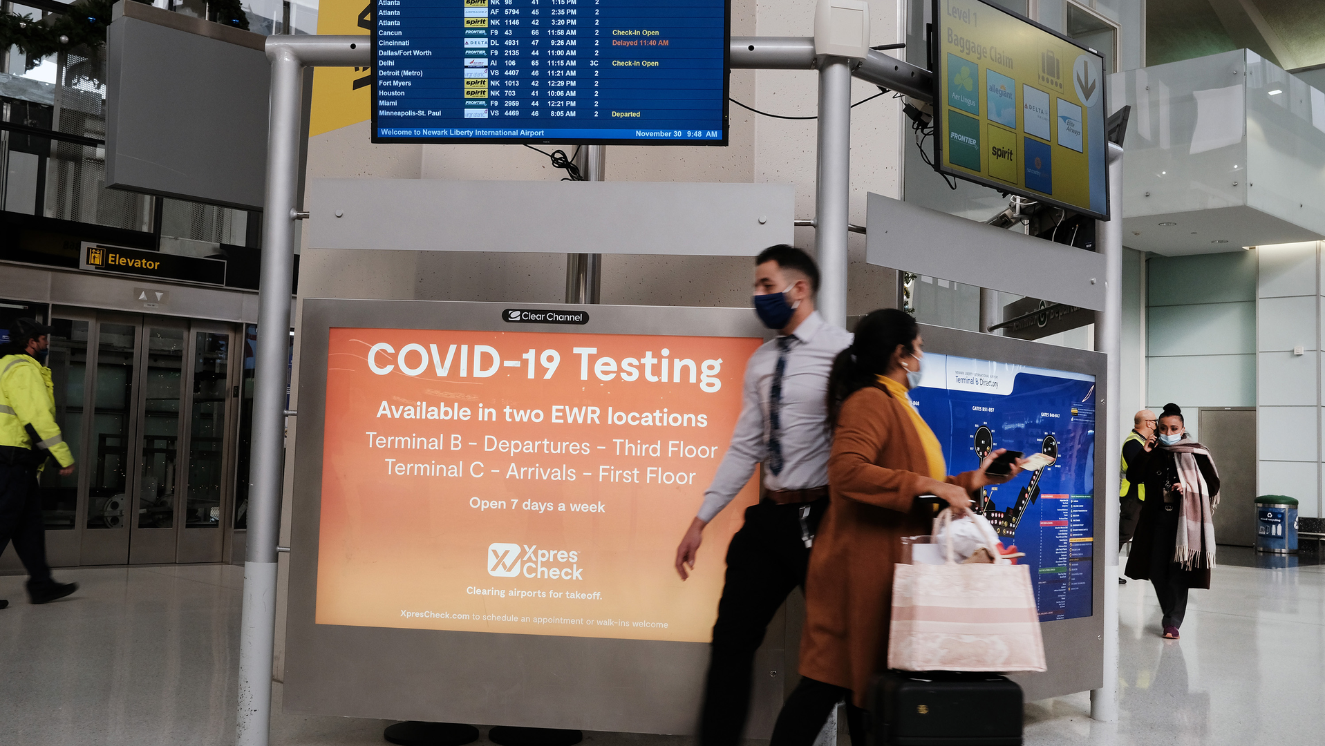 A COVID-19 testing facility is advertised at Newark Liberty International Airport on Tuesday, Nov. 30, 2021 in Newark, New Jersey. The United States, and a growing list of other countries, has restricted flights from southern African countries due to the detection of the COVID-19 Omicron variant last week in South Africa. Stocks in the travel and airline industry have fallen in recent days as fears grow over the spread and severity of the variant.