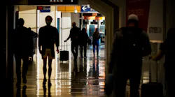 Passengers walk between gates of Terminal E on Saturday, Dec. 11, 2021, at DFW Airport.