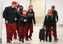A family wearing matching pajama bottoms walks through Terminal A at Orlando International Airport on Christmas Day, Saturday, December 25, 2021. The family was catching a flight to Arizona. A family wearing matching pajama bottoms walks through Terminal A at Orlando International Airport on Christmas Day, Saturday, December 25, 2021. The family was catching a flight to Arizona.