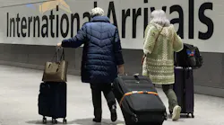 International passengers walk through the arrivals area at Terminal 5 at Heathrow Airport in London on Nov. 26, 2021, two days after the beginning of the spread of the omicron variant was announced.