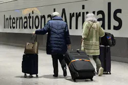 International passengers walk through the arrivals area at Terminal 5 at Heathrow Airport in London on Nov. 26, 2021, two days after the beginning of the spread of the omicron variant was announced.