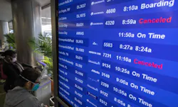 Travelers check for flight information at Los Angeles International Airport in Los Angeles on Dec. 24, 2021. Travelers check for flight information at Los Angeles International Airport in Los Angeles on Dec. 24, 2021.