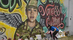 Mellisa Mendoza places white roses at a mural for Vanessa Guillen at a convenience store near Fort Hood on July 6, 2020. Guillen, a soldier whose dismembered remains were found two months after she went missing, told her family she was being sexually harassed at work before she disappeared.