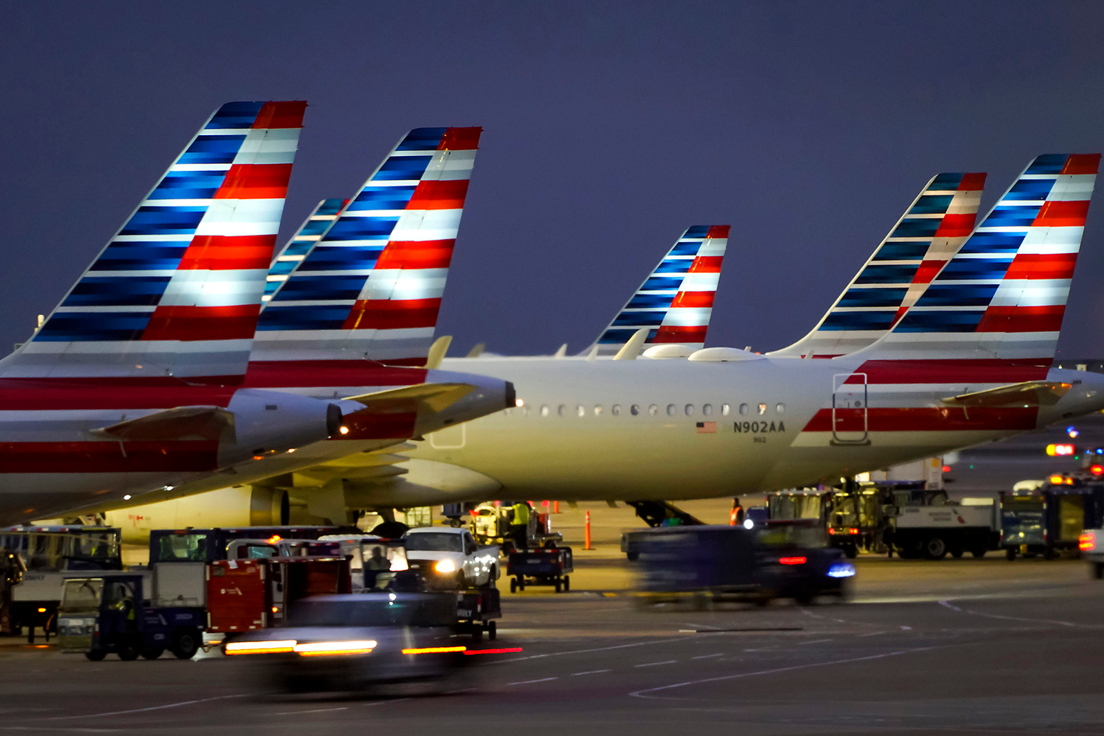 American Airlines planes are seen at the gates of Terminal C at DFW on Friday, Jan. 7, 2022.