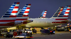 American Airlines planes are seen at the gates of Terminal C at DFW on Friday, Jan. 7, 2022.