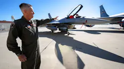 U.S. Air Force Lt. Col Mark Janksy, who pilots the F-16 fighter jet, points to the aircraft after a Super Bowl air defense media briefing at March Air Reserve Base near Riverside on Wednesday, Feb. 9, 2022. Planes at March will join other agencies to protect the skies around SoFi Stadium in Inglewood during the Super Bowl on Sunday, Feb. 13, 2022.