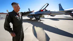 U.S. Air Force Lt. Col Mark Janksy, who pilots the F-16 fighter jet, points to the aircraft after a Super Bowl air defense media briefing at March Air Reserve Base near Riverside on Wednesday, Feb. 9, 2022. Planes at March will join other agencies to protect the skies around SoFi Stadium in Inglewood during the Super Bowl on Sunday, Feb. 13, 2022.