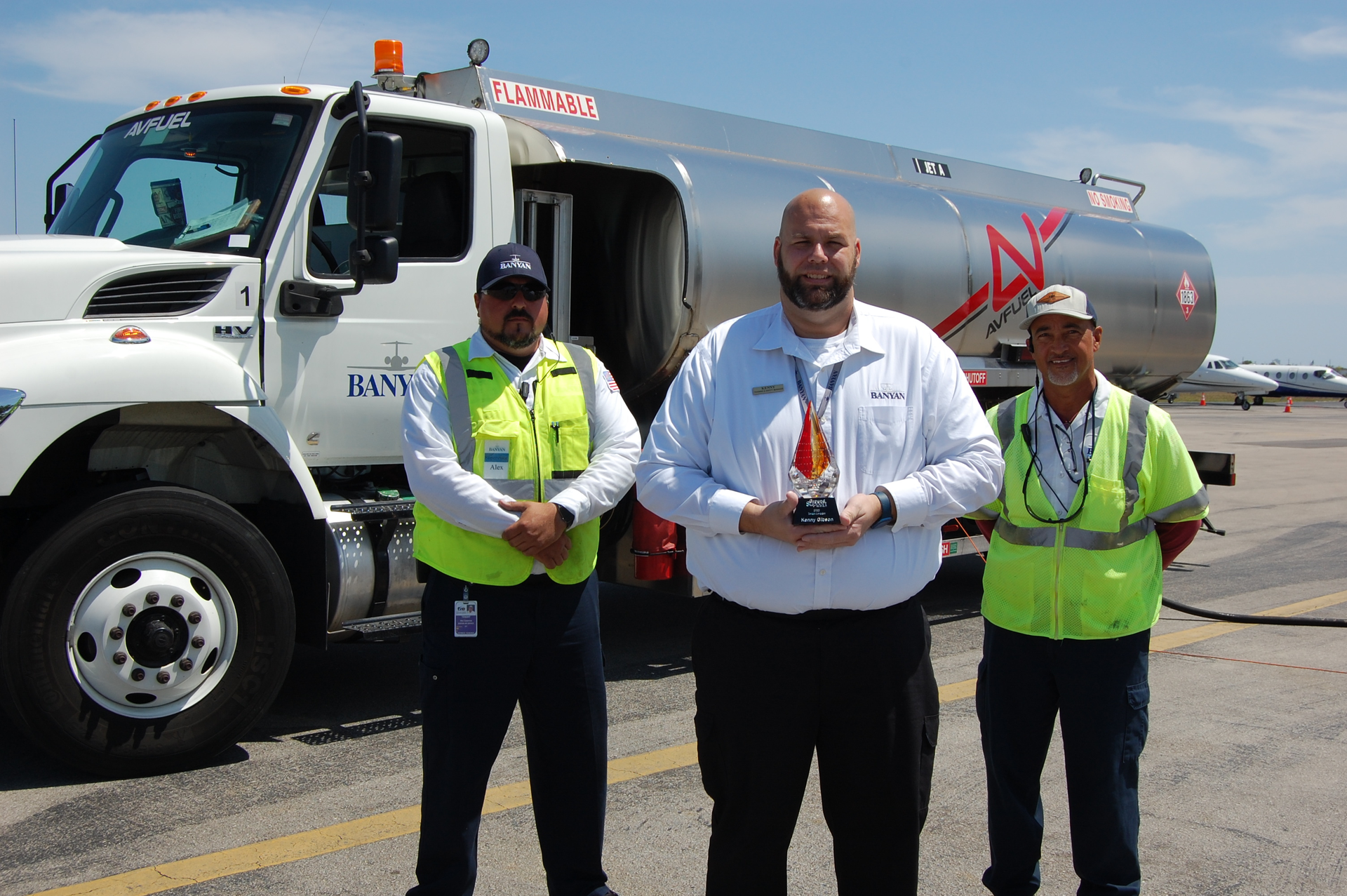2022 Team Leader of the Year Kenny Gibson (center) works closely with line service technicians, including Alex Casanova (left), and on-the-job trainers like Peter Perez. (right).