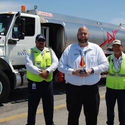 2022 Team Leader of the Year Kenny Gibson (center) works closely with line service technicians, including Alex Casanova (left), and on-the-job trainers like Peter Perez. (right).