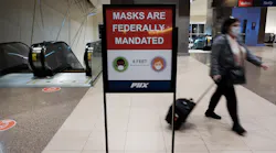 People walk through Sky Harbor International Airport on Dec. 18, 2021, in Phoenix.