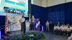 Taking the stage with Airbus executive Daryl Taylor, student trainee Kennedy Brown speaks at a May 9, 2022, event announcing a new Airbus assembly line will be built in Mobile. At right are other students who have participated in the FlightPath9 training program in Mobile