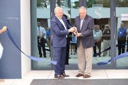 Lee Woodward, CEO, Skyborne (left), and Rick Monday, former Major League Baseball player and sports broadcaster (right), cutting the ribbon in front of the new training center.