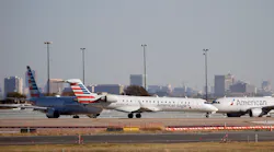American Eagle and American Airlines planes make their way toward the runway before taking off at DFW International Airport in 2020.