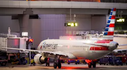 American Airlines planes are seen at the gates of Terminal C at the Skylink train passes overhead on at DFW Airport on Friday, Jan. 7, 2022.