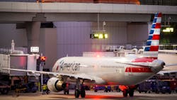 American Airlines planes are seen at the gates of Terminal C at the Skylink train passes overhead on at DFW Airport on Friday, Jan. 7, 2022. American Airlines planes are seen at the gates of Terminal C at the Skylink train passes overhead on at DFW Airport on Friday, Jan. 7, 2022.