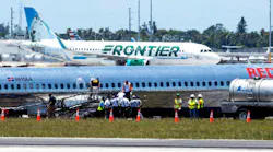 National Transportation Safety Board agents, Federal Aviation Administration agents and Miami-Dade Fire Rescue crews surround RED Air Flight 203 which crash-landed with a fiery emergency landing Tuesday evening, on the tarmac at Miami-International Airport in Miami, Florida, on Wednesday, June 22, 2022.