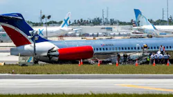 National Transportation Safety Board agents, Federal Aviation Administration agents and Miami-Dade Fire Rescue crews on Wednesday surround the RED Air plane that crash-landed on Tuesday at Miami International Airport.