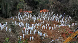 This photo taken on March 27, 2022, shows rescuers standing in a silent tribute for victims at the site of the China Eastern Airlines plane crash in Tengxian county, Wuzhou city, in China's southern Guangxi region. - The Boeing 737-800 was flying between the cities of Kunming and Guangzhou on March 21 when it nosedived into a mountainside, disintegrating on impact and killing all 132 people onboard.