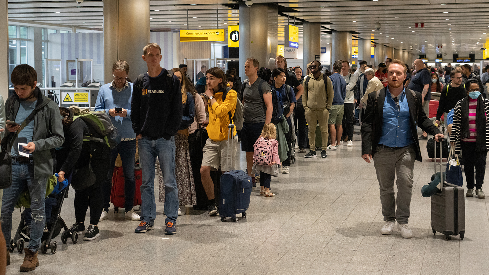 Travelers wait in a long queue to pass through the security check at Heathrow on June 1, 2022, in London, England.