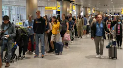 Travelers wait in a long queue to pass through the security check at Heathrow on June 1, 2022, in London, England.