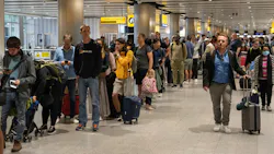 Travelers wait in a long queue to pass through the security check at Heathrow on June 1, 2022, in London, England.