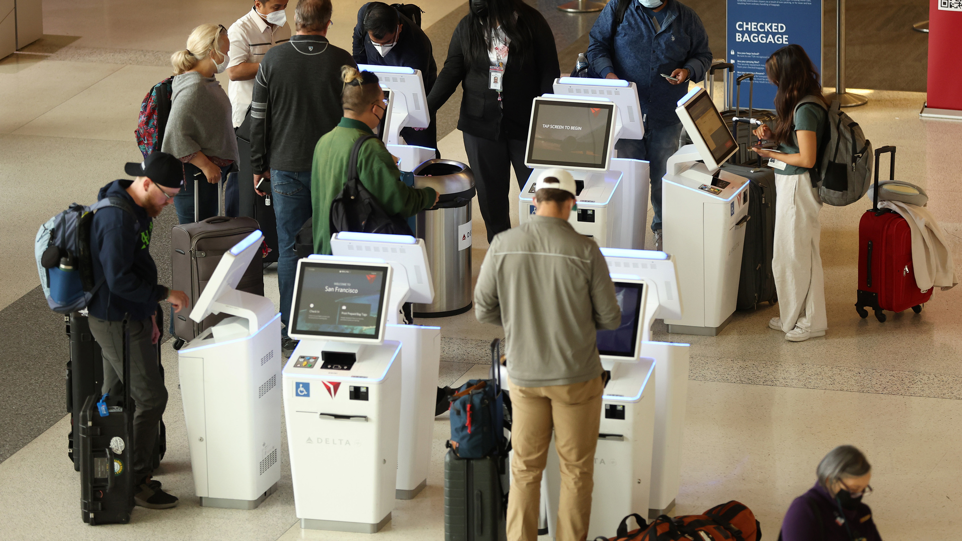 Delta Airlines customers check in for flights at San Francisco International Airport on May 12, 2022, in San Francisco, California.