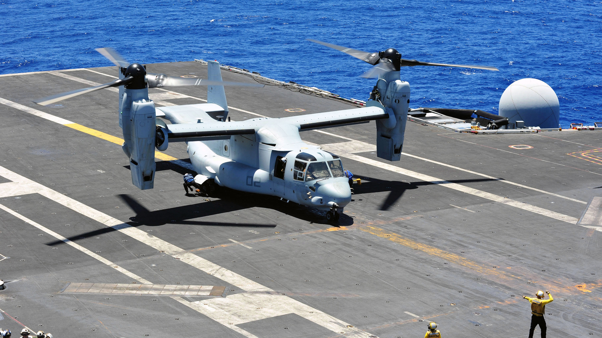 Aviation boatswain's mates chock and chain an MV-22B Osprey in an August 2014 file image.