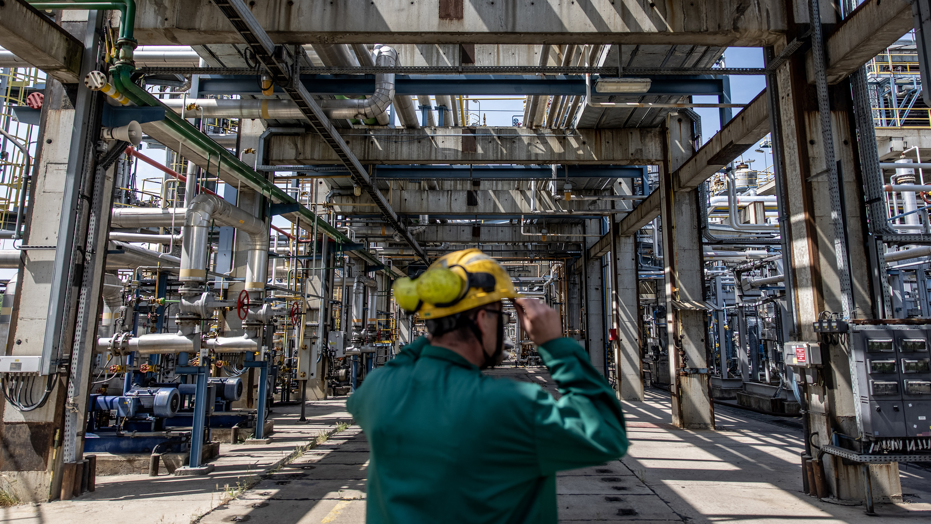 An employee inspects processing and refining structures in the Duna oil refinery on May 24, 2022 in Szazhalombatta, Hungary.