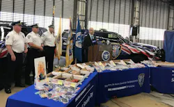 Transportation Security Administration New Jersey director Tom Carter talks about an increase in guns confiscated at Newark Airport at Port Authority Police headquarters at the airport. Confiscated weapons filed three tables in front of him.