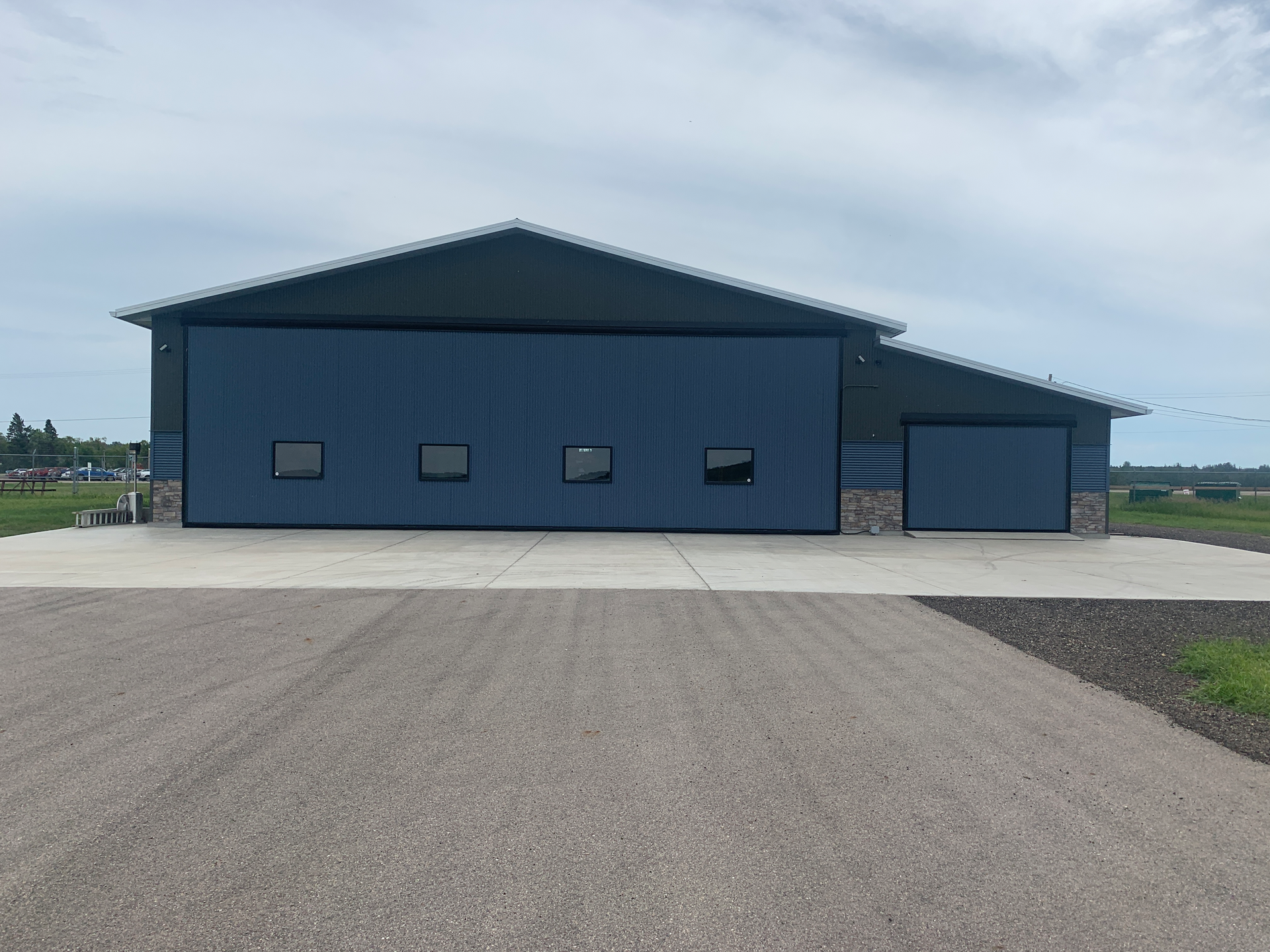 The main Schweiss Doors hydraulic hangar door is 54 feet by 16 feet, 9 inches and an adjacent storage room/garage door measures 13 feet, 3 inches by 8 feet, 11 inches. Four well placed windows on the large hangar door and front hangar windows bring a large amount of natural light into the hangar.